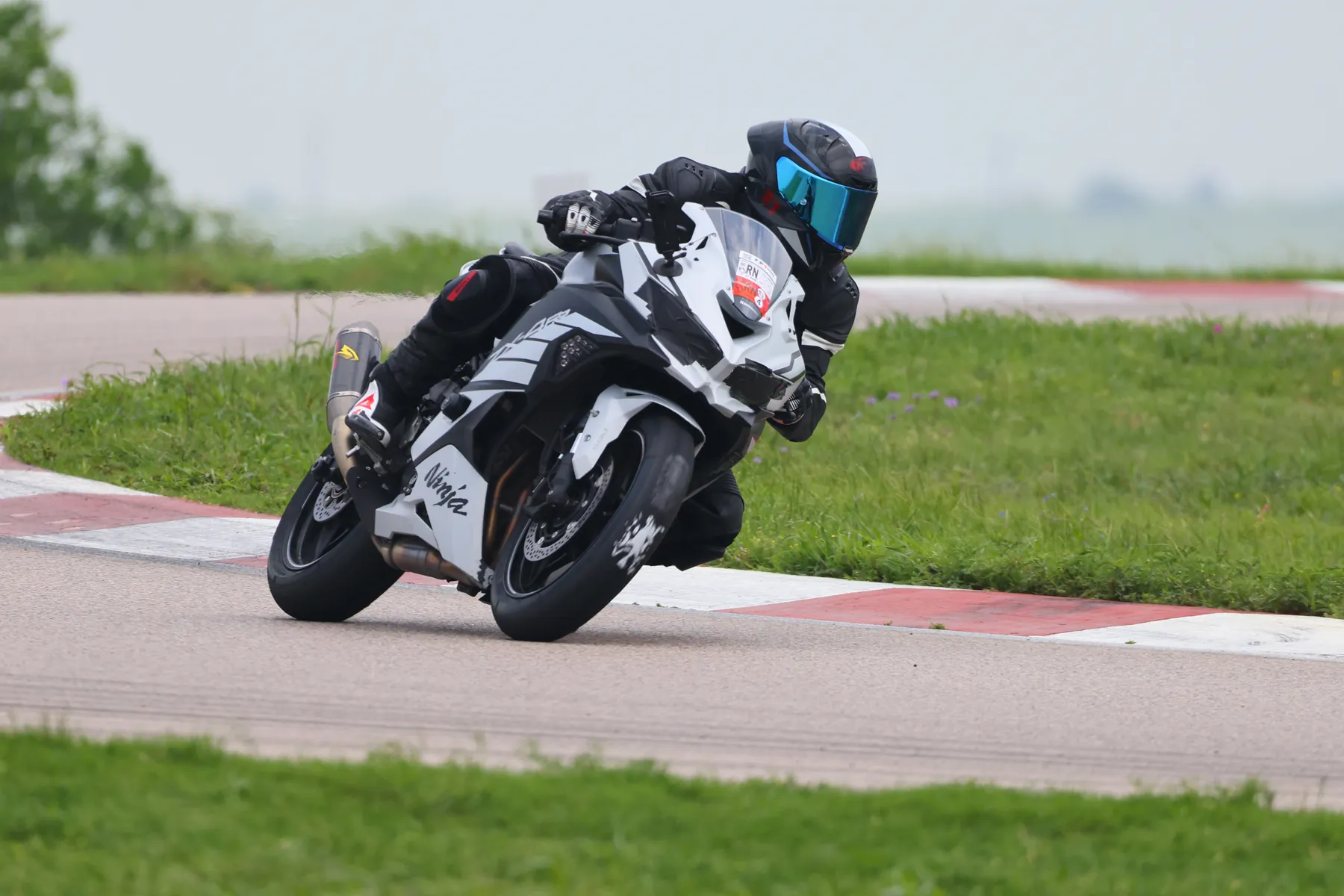 The founder of Ride Home Foundation riding on a racetrack in full protective gear.